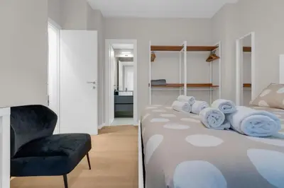 a bedroom with a bed with a chair and towels at SANSO HOUSE - 2 bedrooms, 2 bathrooms, AC - for family in Rome