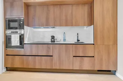 a kitchen with wooden cabinets and a sink at SANSO HOUSE - 2 bedrooms, 2 bathrooms, AC - for family in Rome