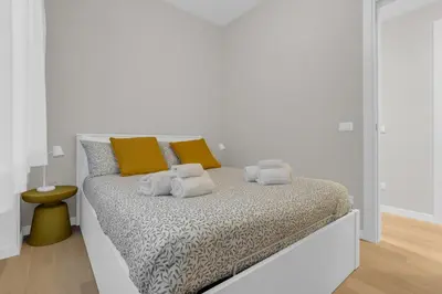 a white bedroom with a bed with towels on it at SANSO HOUSE - 2 bedrooms, 2 bathrooms, AC - for family in Rome