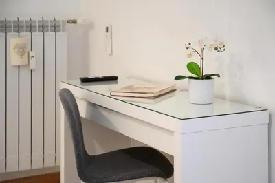 a white desk with a chair and a plant at Da Eleonora - Centro di Roma in Rome