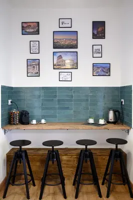 a bar with three stools in a room at Da Eleonora - Centro di Roma in Rome