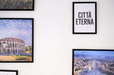 a wall of framed pictures of the coliseum at Da Eleonora - Centro di Roma in Rome