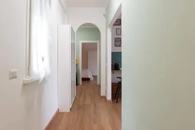 a hallway with white walls and wooden floors at Da Eleonora - Centro di Roma in Rome