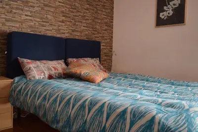 a bed with two pillows on it in a bedroom at Appartamento Elena's House in Rome