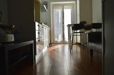 a kitchen with a table and chairs in a room at Appartamento Elena's House in Rome