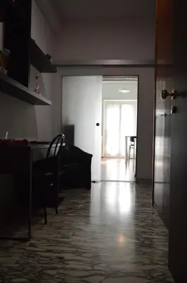 an empty living room with a table and a door at Appartamento Elena's House in Rome