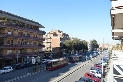 a busy city street with buses and cars and buildings at Appartamento Elena's House in Rome