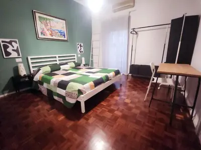 a bedroom with a bed and a table and a desk at BedEpoque - Camera 1 in Rome