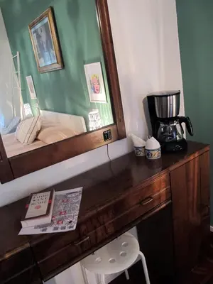 a bedroom with a wooden desk with a mirror at BedEpoque - Camera 1 in Rome