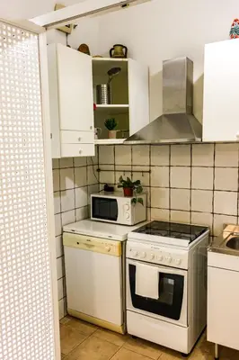 a kitchen with a stove and a microwave at Domus Vaticanae in Rome