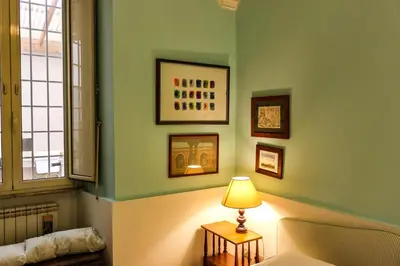 a room with a bed and a lamp on a table at Domus Vaticanae in Rome