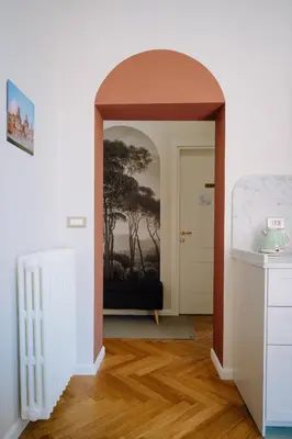 a hallway with an archway in a room at Modern apartment in Cornelia in Rome