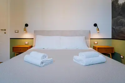 a bedroom with a bed with towels on it at Modern apartment in Cornelia in Rome