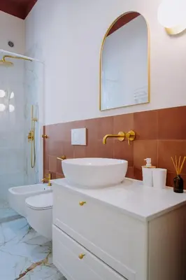 a bathroom with two sinks and a toilet and a mirror at Modern apartment in Cornelia in Rome