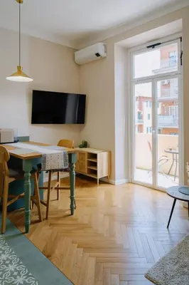 a living room with a table and a flat screen tv at Modern apartment in Cornelia in Rome
