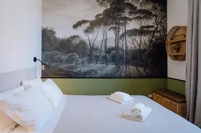 a bedroom with a bed with towels on it at Modern apartment in Cornelia in Rome
