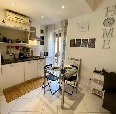 a kitchen with a glass table and a dining room at Vatican Loft a pochi passi da piazza San Pietro in Rome