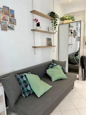 a gray couch with pillows in a living room at Vatican Loft a pochi passi da piazza San Pietro in Rome