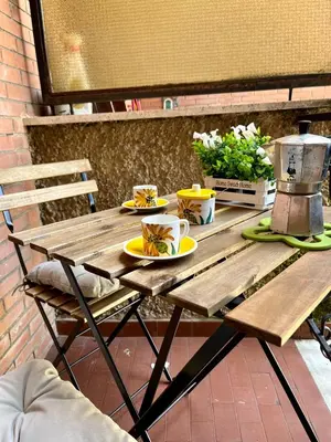 a wooden picnic table with plates of food on it at Vatican Loft a pochi passi da piazza San Pietro in Rome