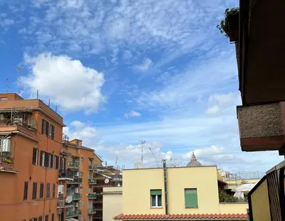 a view of a city with buildings and a blue sky at Vatican Loft a pochi passi da piazza San Pietro in Rome