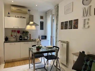a small kitchen with a table and a table and chairs at Vatican Loft a pochi passi da piazza San Pietro in Rome