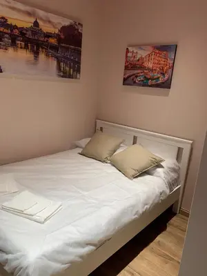 a white bed with two pillows on top of it at eternal - vatican trionfale in Rome