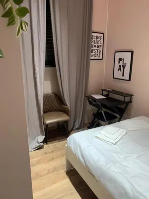 a bedroom with a bed and a table and a chair at eternal - vatican trionfale in Rome