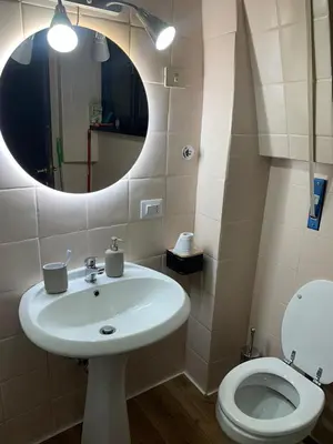 a bathroom with a sink and a toilet with a mirror at eternal - vatican trionfale in Rome