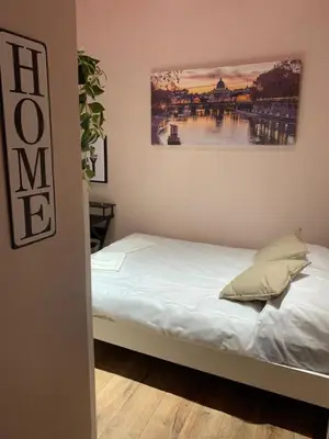 a bed in a room with a painting on the wall at eternal - vatican trionfale in Rome