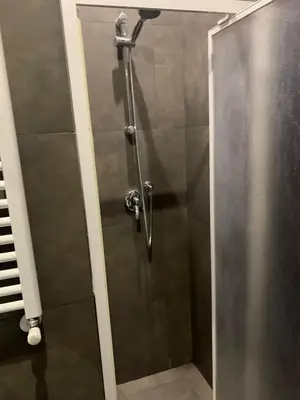 a shower with a glass door in a bathroom at unica-vatican museum in Rome