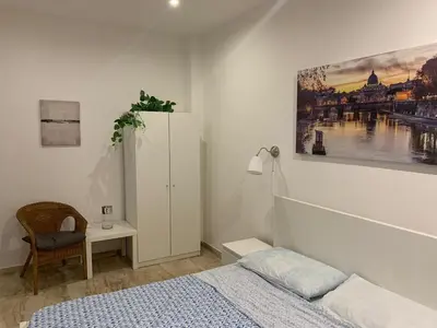 a bedroom with a bed and a painting on the wall at unica-vatican museum in Rome