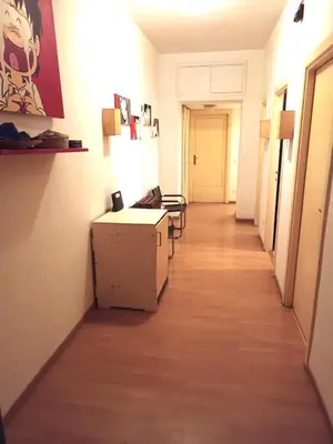 a hallway with a long corridor with tables and chairs at Camera Privata Nomentana per medio lungo periodo in Rome