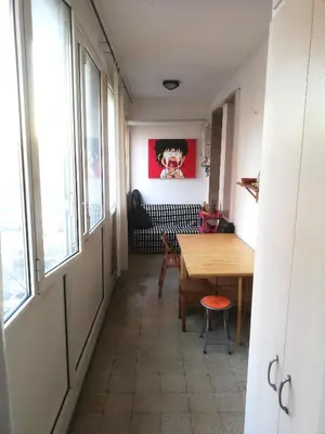 a hallway with a table and a bench in a room at Camera Privata Nomentana per medio lungo periodo in Rome