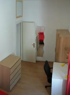 a room with a desk and a chair and a door at Camera Privata Nomentana per medio lungo periodo in Rome