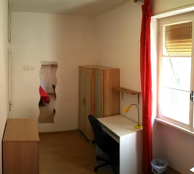 a room with a desk and a chair and a window at Camera Privata Nomentana per medio lungo periodo in Rome