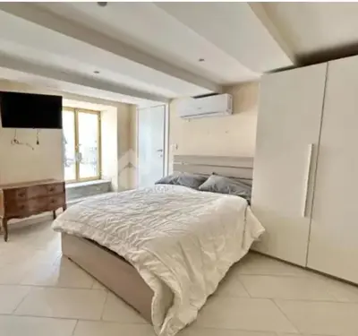 a bedroom with a large bed and a television at Il Colosseo Holiday home in Rome