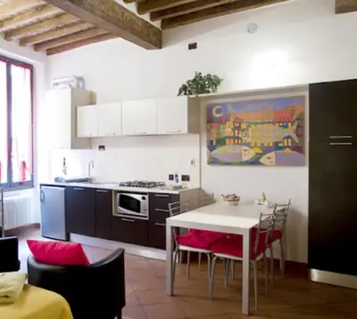 a kitchen with a table and a table and chairs at Il Colosseo Holiday home in Rome