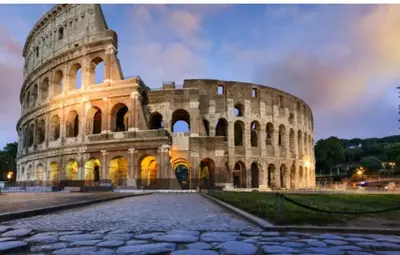 a large building with the colosseum at night at Il Colosseo Holiday home in Rome