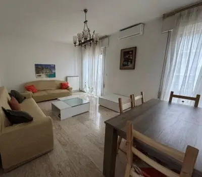 a living room with a table and a couch at Il Colosseo Holiday home in Rome