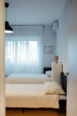a bedroom with two beds and a window at Roma Urban Retreat in Rome