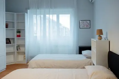 a bedroom with two beds and a window at Roma Urban Retreat in Rome