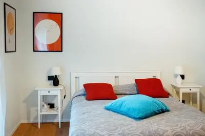a bedroom with a bed with red and blue pillows at Roma Urban Retreat in Rome