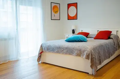 a bedroom with a bed with red and blue pillows at Roma Urban Retreat in Rome