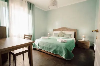a bedroom with a bed with two towels on it at Dream Vacation Suites in Rome