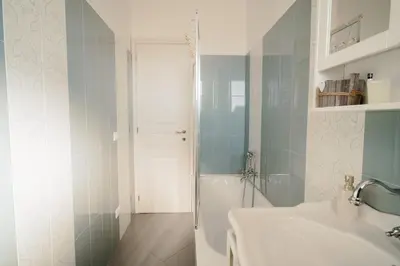 a bathroom with a white sink and a shower at Dream Vacation Suites in Rome