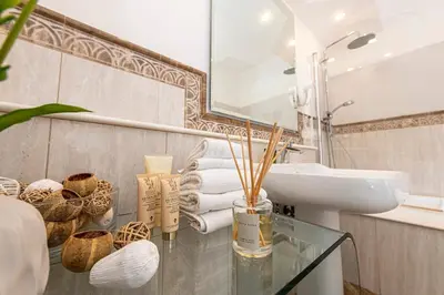 a bathroom with a glass table and a sink at Maisondesfleurs in Rome