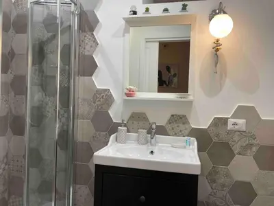 a bathroom with a sink and a shower at Rome City Center Apartment in Rome