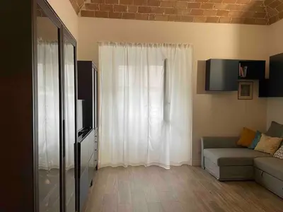 a living room with a couch and a window at Rome City Center Apartment in Rome