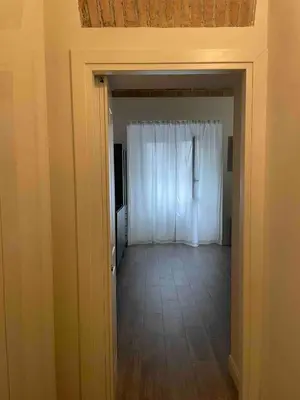 an empty room with a white curtain and a door at Rome City Center Apartment in Rome