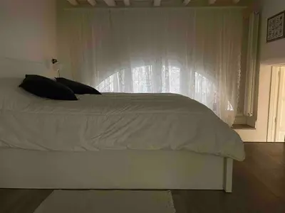 a bedroom with a white bed with a window at Rome City Center Apartment in Rome